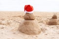 New Year or Merry Christmas sand snowman on ocean beach Royalty Free Stock Photo