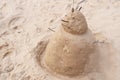 New Year or Merry Christmas sand snowman on ocean beach Royalty Free Stock Photo