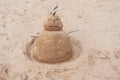 New Year or Merry Christmas sand snowman on ocean beach Royalty Free Stock Photo