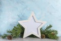 New year mockup: christmas tree branches with white star shaped photo frame on blue background. Holidays concept. Text space, copy Royalty Free Stock Photo