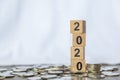 2010 New year, Money and Business Concept. Close up of stack of number wooden block toy on pile of coins white background Royalty Free Stock Photo