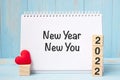 New Year New You words and 2022 cubes with red heart shape decoration on blue wooden table background. Goal, Resolution, health, Royalty Free Stock Photo