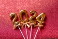 2024 New Year numbers Concept - Orange old gold numbers on red glitter background Royalty Free Stock Photo