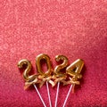 2024 New Year numbers Concept - Orange old gold numbers on red glitter background Royalty Free Stock Photo