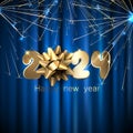 New Year 2024 numbers made of golden foil on blue satin cloth background with flying firework light particles