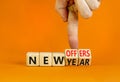 New year and offers symbol. Concept word New year New offers on beautiful wooden cubes. Beautiful orange table orange background. Royalty Free Stock Photo