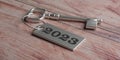 2023 New Year, old silver door key and tag number on wooden table