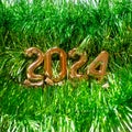 New Year 2024 - Orange old gold numbers on light green glitter grass background