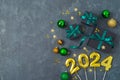 New Year 2024 party background with decorations and black gift boxes. Top view, flat lay