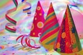 New Year party background with party hats, confetti and serpentines, colorful lights Royalty Free Stock Photo