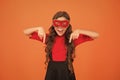 New year party. Carnival party. Masquerade concept. Kid wear eye mask. Girl wear mask orange background. Event and