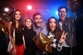 New year party, holidays, celebration, nightlife and people concept - Young people having fun dancing at a party