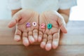 2020 New Year Planning Concept. Close up of colorful wooden number on woman hand on wooden table Royalty Free Stock Photo