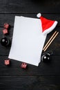 New year plans empty paper and Christmas tree decoration, top view flat lay , with copy space for text , on black wooden table Royalty Free Stock Photo