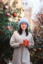 New year portrait of happy girl in oversize chunk knit hat on christmas shopping Royalty Free Stock Photo