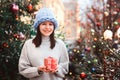 new year portrait of happy girl in oversize chunk knit hat on christmas shopping at city holiday market Royalty Free Stock Photo