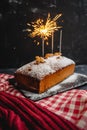 New year pound cake with Christmas spices and a bengal light sparkler. festive traditional bread on a black background Royalty Free Stock Photo