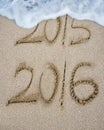 New year 2016 replace 2015 on sand beach Royalty Free Stock Photo