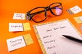 New Year Resolution and plan concept with paper and sticker on orange background Royalty Free Stock Photo