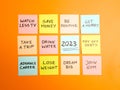 New Year 2023 resolutions handwritten on colorful sticky notes on orange background. Future planning, motivation, change and