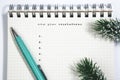 new year resolutions, Notebook and green pen with conifer branch Royalty Free Stock Photo