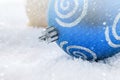 New Year`s background with blue and yellow Christmas balls on the snow. Royalty Free Stock Photo