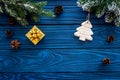 New year`s background. Christmas toys, present, spruce branches, pine cone on blue wooden background top view copyspace Royalty Free Stock Photo