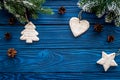 New year`s background. Christmas toys, spruce branches, pine cone on blue wooden background top view copyspace Royalty Free Stock Photo