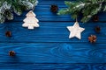 New year`s background. Christmas toys, spruce branches, pine cone on blue wooden background top view copyspace Royalty Free Stock Photo