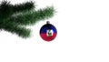 New Year`s ball with the flag of Haiti on a Christmas tree branch isolated on white background. Christmas and New Year concept Royalty Free Stock Photo