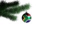 New Year`s ball with the flag of South Africa on a Christmas tree branch isolated on white background. Christmas and New Year Royalty Free Stock Photo