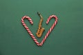 New Year`s card - golden saxophone and candy cane. Green backgro