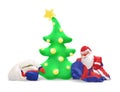 Deflated and crumpled Santa Claus and a snowman under an inflatable Christmas tree with a star and golden balloons Royalty Free Stock Photo