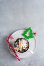 New Year`s chocolate cake cooked in microwave oven in mug on vintage gray background texture. Top view. New Year card