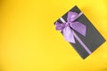 New year`s Christmas birthday mother`s day holiday background gift box black gift box with purple purple fuchsia ribbon and bow on Royalty Free Stock Photo