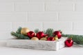 New Year`s or Christmas composition. white wooden box with Christmas red and gold balls, branches of spruce on a wooden table Royalty Free Stock Photo