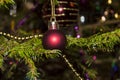 Christmas toys against the background of green branches and lights