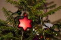 Christmas toys against the background of green branches and lights