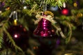 Christmas toys against the background of green branches and lights