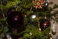 Christmas toys against the background of green branches and lights