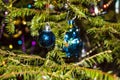 Christmas toys against the background of green branches and lights