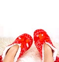 New Year`s, Christmas slippers for adults are dressed for the child. On white soft fur. Funny, funny, humorous, cozy Royalty Free Stock Photo