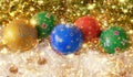 New Year`s, Christmas still life. Handmade decorated green, red, blau, yellow balls in showflocken on the gold tinsel with lights Royalty Free Stock Photo