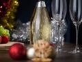 New Year``s and Christmas themed still life, Champagne bottle and flutes in focus, Decoration out of focus in boke Royalty Free Stock Photo