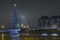 New Year`s Christmas tree and New Year`s garlands on the trees in the Stock Square on Strelka of the Vasilyevsky Island in St. Pet