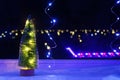 New Year's Christmas tree on the window on background of the night city. Garlands, lights, bokeh. Royalty Free Stock Photo