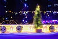 New Year's Christmas tree on the window on background of the night city. Garlands, lights, bokeh. Royalty Free Stock Photo