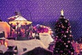 New Year`s city in miniature with carousel for children, Christmas tree, snow roads.Frame colors: violet, purple, white, yellow Royalty Free Stock Photo