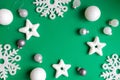 New Year's composition. Christmas white decorations on a green background with space for text. Layout of a postcard, poster Royalty Free Stock Photo