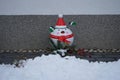 New Year\'s composition. Decorative Penguin in a Christmas costume in the garden. Germany
